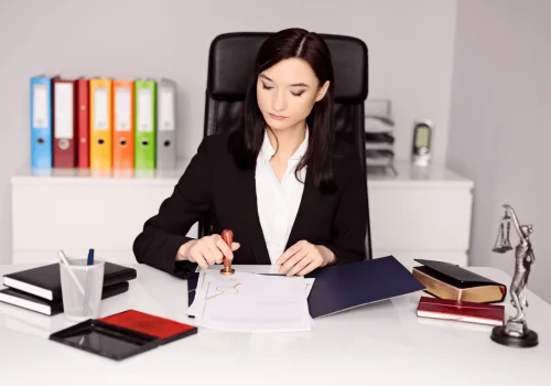Lawyer in office applying an official seal to documents, representing agreement validation